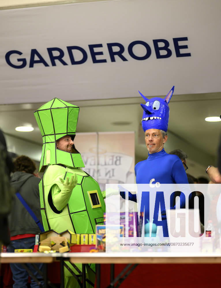 Feature: Two people in costume at the trade show; behind them is the coat check area; new product showcase; on October 21, 2026, at the SPIEL Essen trade show, October 22–25, 2026, in Essen, Germany, at the Grugahalle