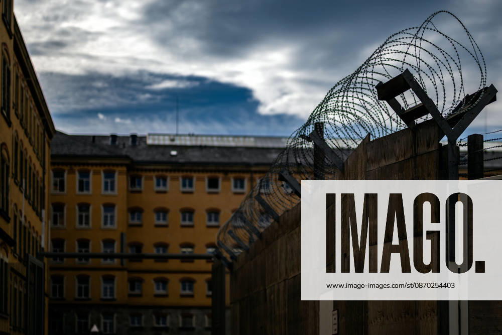 Germany, Saxony, Bautzen: A surveillance camera and a streetlight in front of the historic buildings of the Bautzen Correctional Facility in Saxony. The prison complex is secured by walls and security fences.