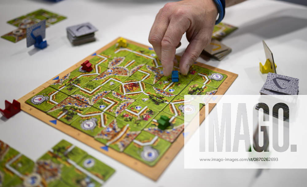 Feature: The game Carcassonne Labyrinth, a collaboration between Ravensburger and Hans im Glück; a player draws a game piece, New Product Showcase, October 21, 2026; SPIEL Essen trade show from October 22–25, 2026, in Essen, Germany, Grugahalle