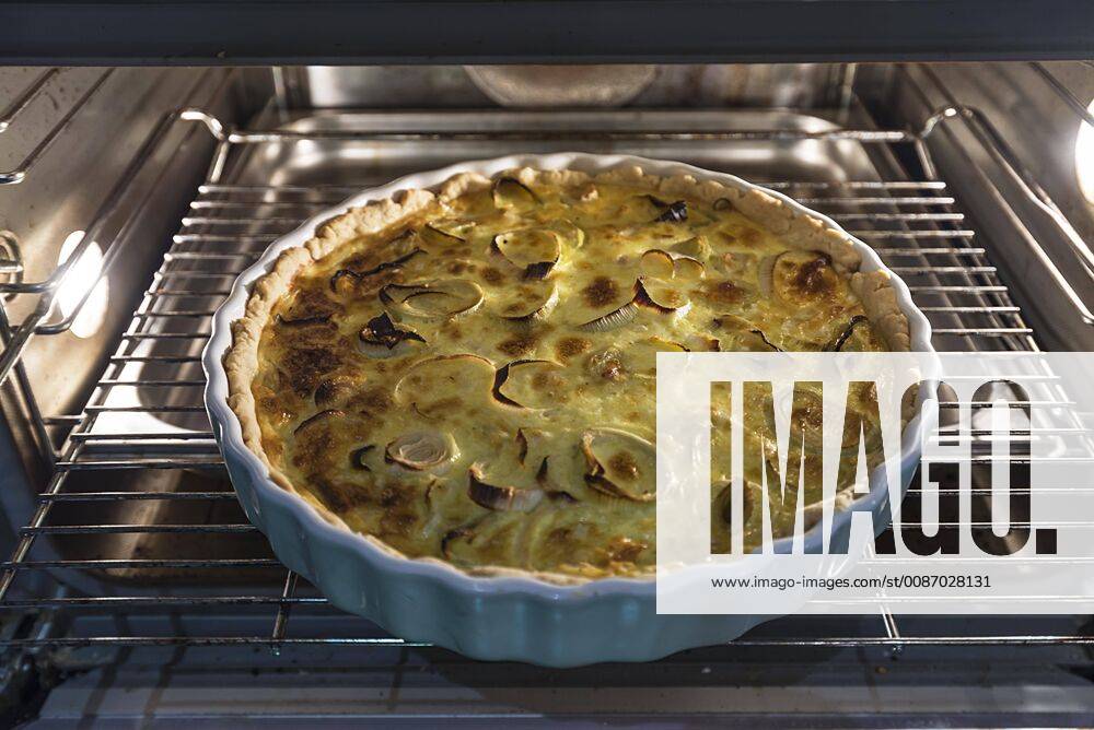 Baked leek quiche in round form in the oven Germany Europe