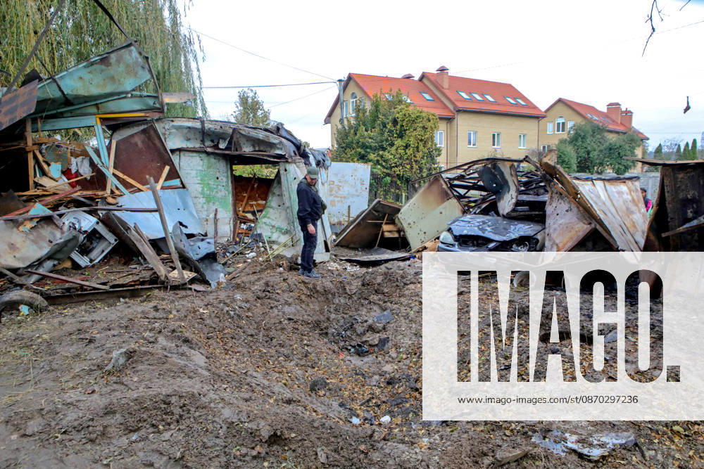 A man looks at a crater in the ground near destroyed garages left by a Russian drone attack, Petropavlivska Borshchahivka, Kyiv region, Ukraine, October 21, 2026. (Photo by Volodymyr Tarasov Ukrinform) Consequences of Russian drone attack in Kyiv region