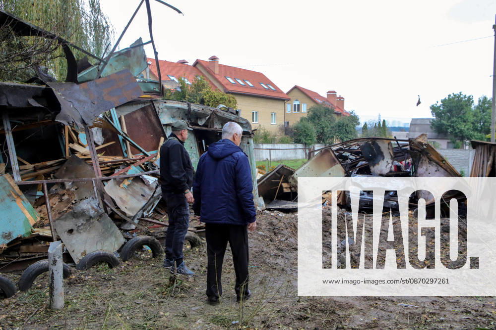 Two men face a burnt-out car in a garage destroyed by a Russian drone attack, Petropavlivska Borshchahivka, Kyiv region, Ukraine, October 21, 2026. (Photo by Volodymyr Tarasov Ukrinform) Consequences of Russian drone attack in Kyiv region