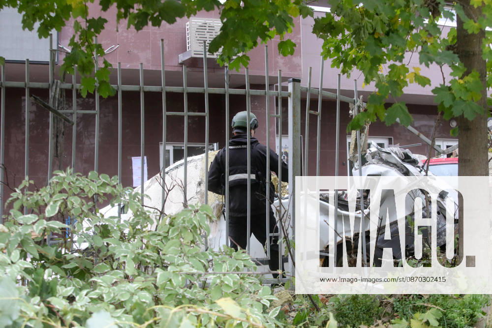 A forensic expert stands by a car damaged by a Russian drone strike on an apartment block in the Sviatoshynskyi district, Kyiv, Ukraine, October 21, 2026. The drone hit the building’s 20th floor, sparking a fire. Two people were killed in the attack. (Photo by Volodymyr Tarasov Ukrinform) Russian drone hits 24-storey apartment block in Kyiv