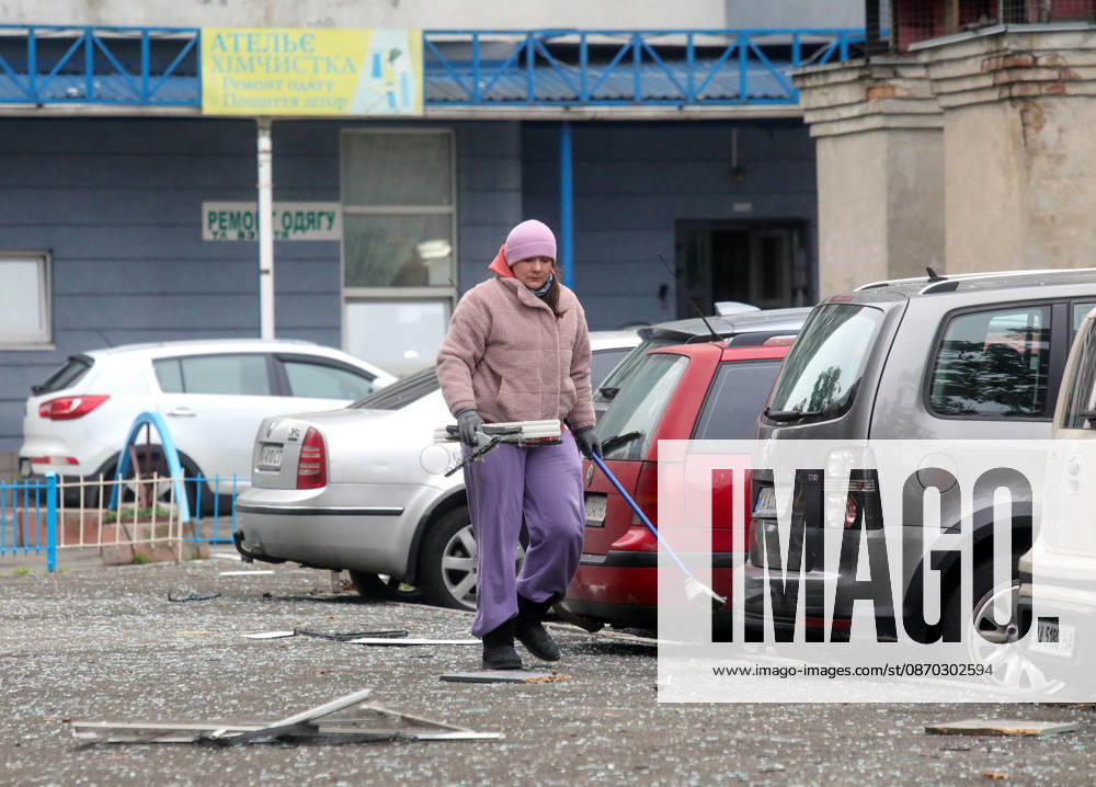 A woman removes glass shards outside an apartment block in the Sviatoshynskyi district damaged by a Russian drone strike, Kyiv, Ukraine, October 21, 2026. The drone hit the building’s 20th floor, sparking a fire. Two people were killed in the attack. (Photo by Volodymyr Tarasov Ukrinform) Russian drone hits 24-storey apartment block in Kyiv