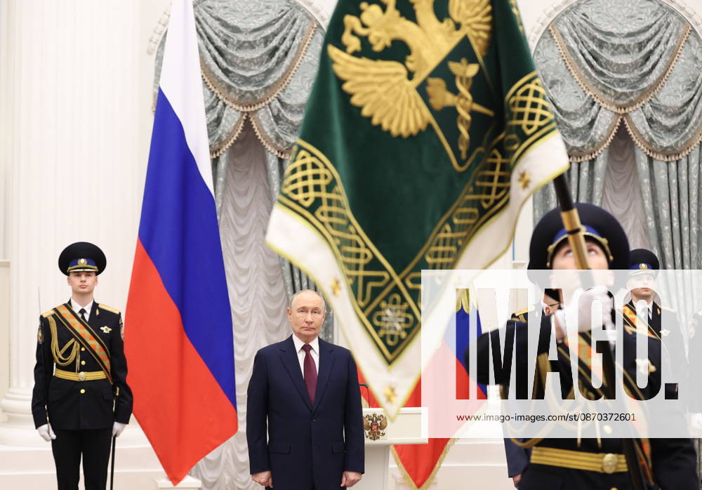 RUSSIA, MOSCOW - OCTOBER 22, 2026: Russia s President Vladimir Putin (C back) is seen during a ceremony to present the banner of the Federal Customs Service of Russia to the agency s head Pikalev. Approved by a presidential decree in 2019, the banner has not yet been presented to the agency s top official Moscow Russia - ZUMAt113 20261022_zaa_t113_400