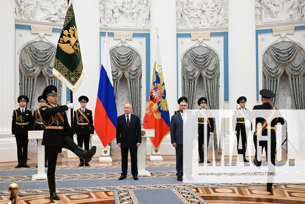 RUSSIA, MOSCOW - OCTOBER 22, 2026: Russia s President Vladimir Putin (CL midground) presents the banner of the Federal Customs Service of Russia to the agency s head Valery Pikalev (CR midground) during a ceremony at the Kremlin. Approved by a presidential decree in 2019, the banner has not yet been presented to the agency s top official. Pelageya Tikhonova POOL TASS 99765237