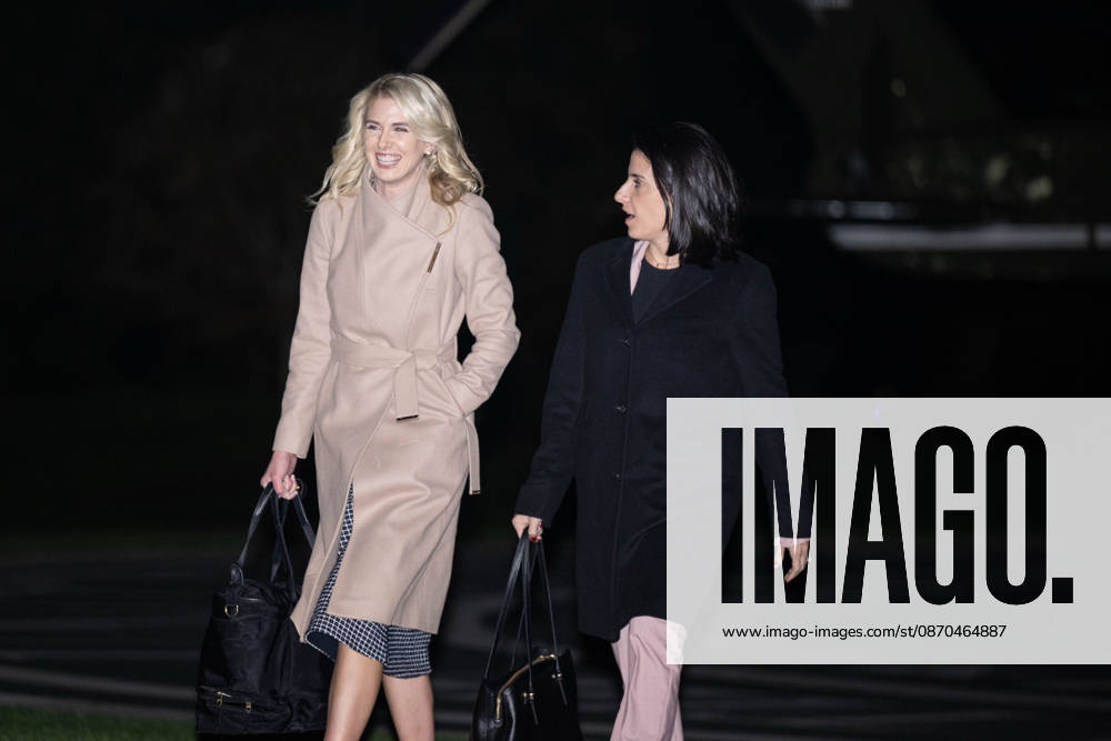 NATALIE HARP and DANIELLE ALVAREZ walk toward the White House following President DONALD TRUMPs return from a campaign rally in Sioux City, Iowa. Washington United States - ZUMAk206 20261023_znp_k206_006