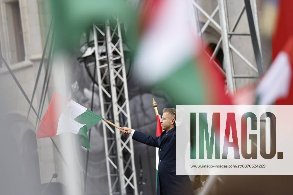 Hungary marks the 70th anniversary of failed 1956 counter-revolution BUDAPEST, HUNGARY - OCTOBER 23: People wave Hungarian flags as Hungarian Prime Minister Peter Magyar gives a speech in front of the Hungarian Parliament Building on October 23, 2026 in Budapest, Hungary. A national program of commemoration events are taking place to mark the 70th anniversary of Hungary s failed 1956 counter-revolution, during which an estimated 2,500 - 3,000 Hungarians were killed amid a Soviet crackdown. Foreign guests, including European Commission President Ursula von der Leyen, are attending a speech by Hungarian Prime Minister Peter Magyar to mark the anniversary of the uprising. Arpad Kurucz Anadolu Budapest Hungary. Editorial use only. Please get