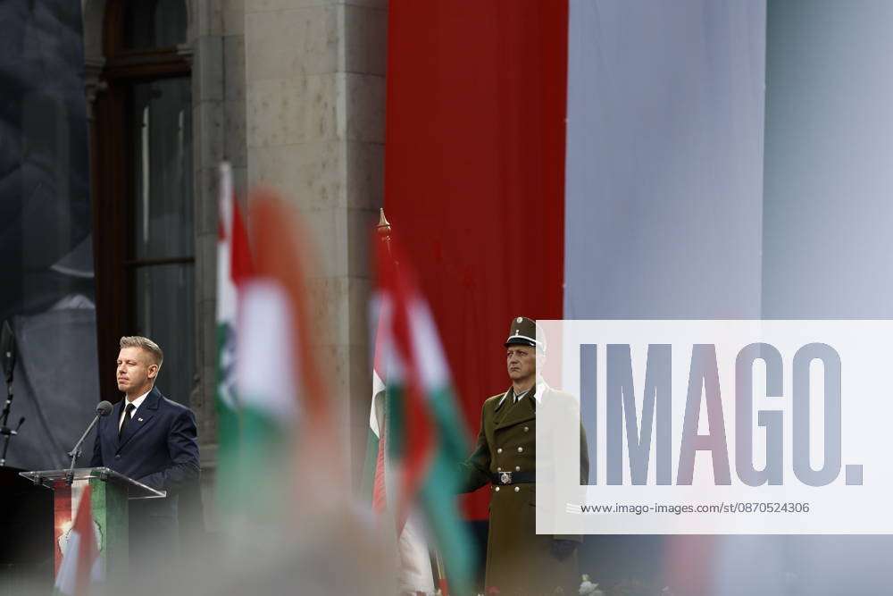 Hungary marks the 70th anniversary of failed 1956 counter-revolution BUDAPEST, HUNGARY - OCTOBER 23: People wave Hungarian flags as Hungarian Prime Minister Peter Magyar gives a speech in front of the Hungarian Parliament Building on October 23, 2026 in Budapest, Hungary. A national program of commemoration events are taking place to mark the 70th anniversary of Hungary s failed 1956 counter-revolution, during which an estimated 2,500 - 3,000 Hungarians were killed amid a Soviet crackdown. Foreign guests, including European Commission President Ursula von der Leyen, are attending a speech by Hungarian Prime Minister Peter Magyar to mark the anniversary of the uprising. Arpad Kurucz Anadolu Budapest Hungary. Editorial use only. Please get