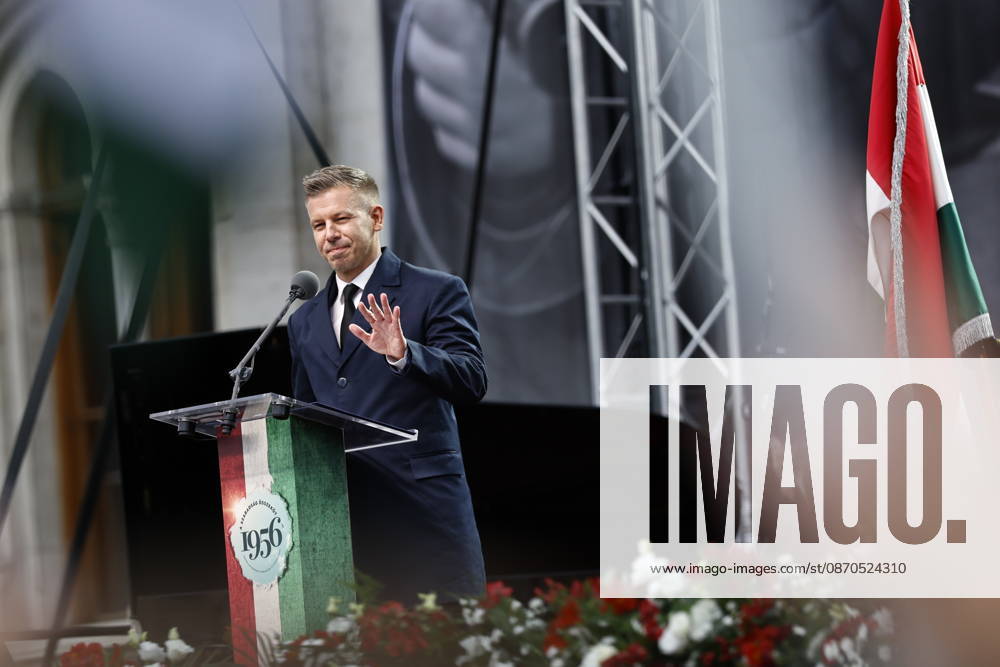 Hungary marks the 70th anniversary of failed 1956 counter-revolution BUDAPEST, HUNGARY - OCTOBER 23: People wave Hungarian flags as Hungarian Prime Minister Peter Magyar gives a speech in front of the Hungarian Parliament Building on October 23, 2026 in Budapest, Hungary. A national program of commemoration events are taking place to mark the 70th anniversary of Hungary s failed 1956 counter-revolution, during which an estimated 2,500 - 3,000 Hungarians were killed amid a Soviet crackdown. Foreign guests, including European Commission President Ursula von der Leyen, are attending a speech by Hungarian Prime Minister Peter Magyar to mark the anniversary of the uprising. Arpad Kurucz Anadolu Budapest Hungary. Editorial use only. Please get