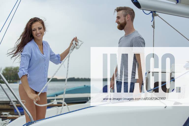 Couple unmooring sailing boat model released Symbolfoto property released JZF00014