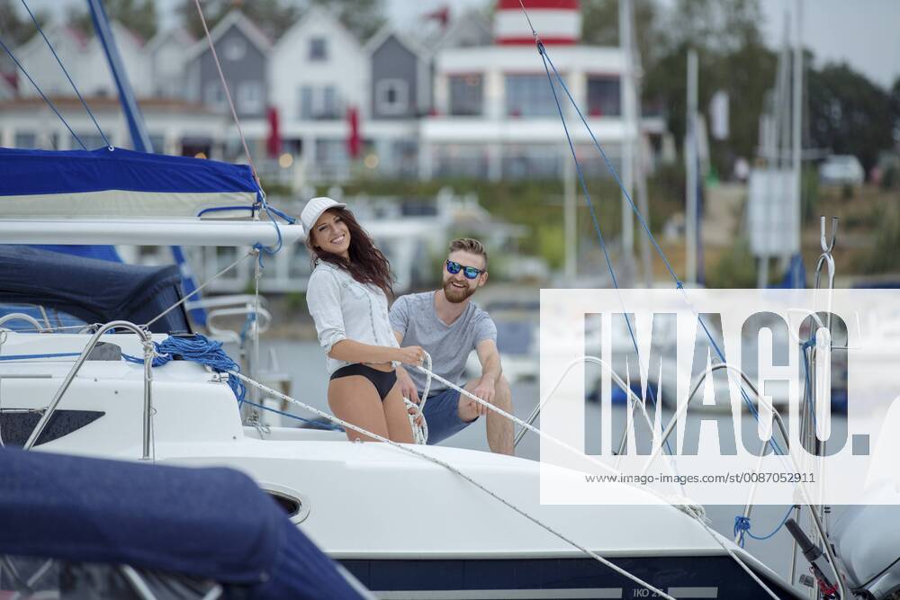 Couple unmooring sailing boat model released Symbolfoto property released JZF00016