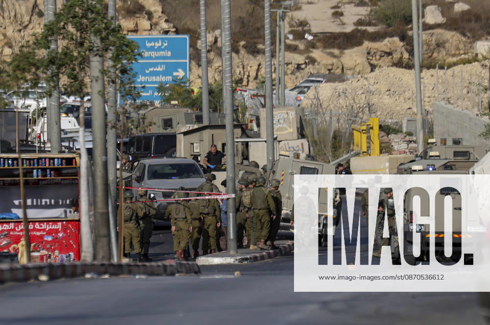 Hebron West Bank Shooting Attack Israeli military forces gather at the entrance to Farsh al-Hawa near Hebron, in the occupied West Bank on October 23, 2026. Journalists were targeted and the area was declared a closed military zone following a Palestinian shooting attack targeting an Israeli military checkpoint at the entrance to Farsh al-Hawa in Hebron. Hebron West Bank Palestinian Territories