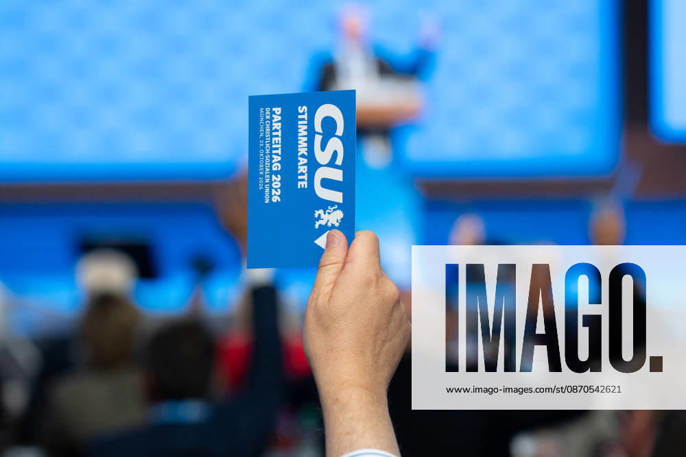 Munich, Bavaria, Germany October 23, 2026: The 2026 convention of the CSU (Christian Social Union) at the Munich Trade Fair Center. A hand holds a voting card aloft