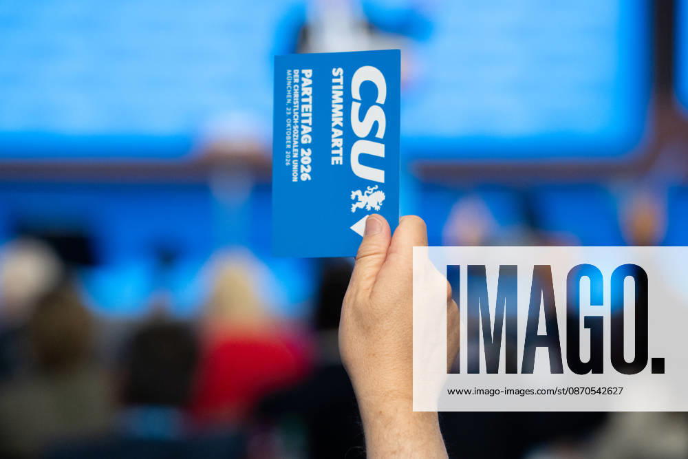 Munich, Bavaria, Germany October 23, 2026: The 2026 convention of the CSU (Christian Social Union) at the Munich Trade Fair Center. A hand holds a voting card aloft