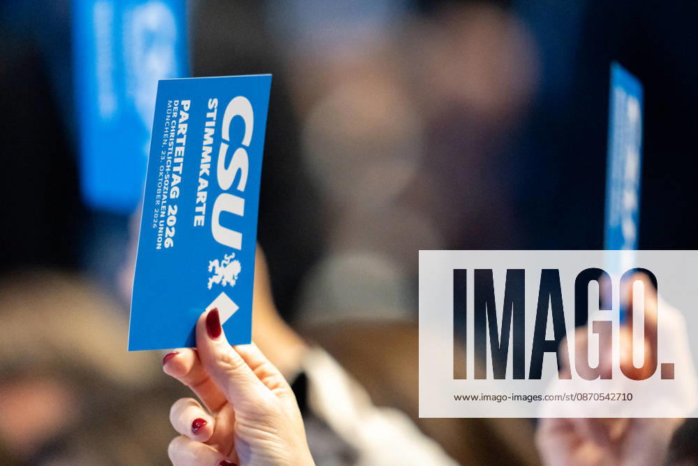 Munich, Bavaria, Germany October 23, 2026: The 2026 convention of the CSU (Christian Social Union) at the Munich Trade Fair Center. A hand holds a voting card aloft