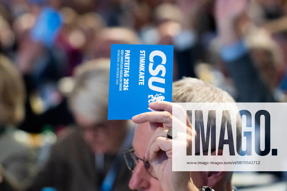 Munich, Bavaria, Germany October 23, 2026: The 2026 convention of the CSU (Christian Social Union) at the Munich Trade Fair Center. A hand holds a voting card aloft
