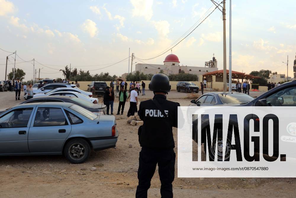 (261023) -- KARAK, Oct. 23, 2026 -- A police officer stands guard outside the church where a shooting attack occurred during a funeral in Jordan s southern governorate of Karak, Jordan, Oct. 23, 2026. Seven people were killed and 34 others injured in a shooting attack during a funeral in Jordan s southern governorate of Karak, the Jordanian Public Security Directorate said Friday. (Photo by Xinhua) JORDAN-KARAK-CHURCH SHOOTING MohammadxAbuxGhosh