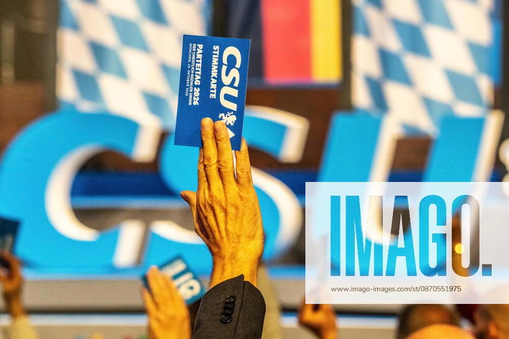 Delegates use their voting cards to approve one of the motions; motion deliberations on Friday evening; CSU Party Convention; Messe München; October 23, 2026, Germany; Munich, October 23, 2026, delegates use their voting cards to approve one of the motions, CSU logo in the background, motion deliberations on Friday evening, CSU Party Convention on October