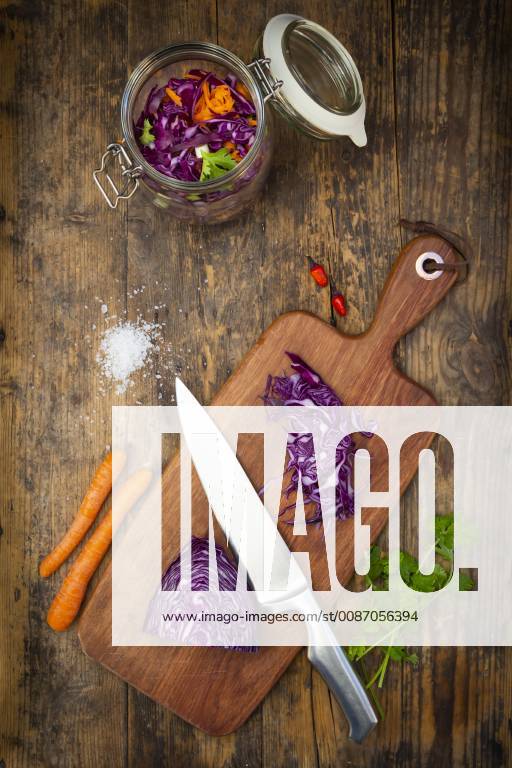 Homemade red cabbage, fermented, with chili, carrot and coriander, preserving jar on wood LVF07485