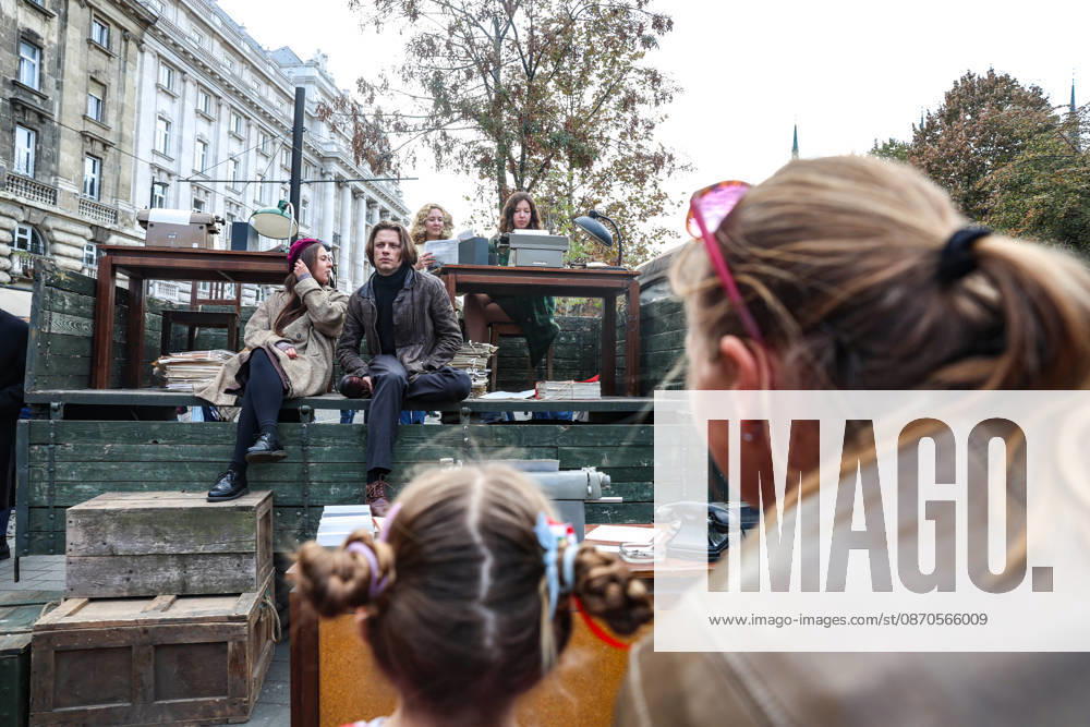 A young girl and her mother look at two young demonstrators in period clothing sitting aboard a vintage truck during a historical reenactment of the 1956 Hungarian Revolution, marking its 70th anniversary in Budapest. Budapest Hungary - ZUMAo116 20261023_znp_o116_003