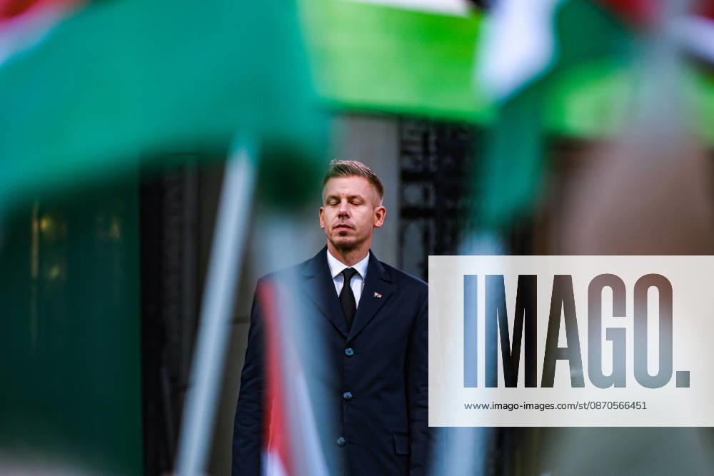 With his eyes closed, Hungarian Prime Minister PETER MAGYAR stands framed by blurred Hungarian flags during commemorations marking the 70th anniversary of the 1956 Hungarian Revolution outside Parliament, his first October 23 ceremony as prime minister. Budapest Hungary - ZUMAo116 20261023_znp_o116_059