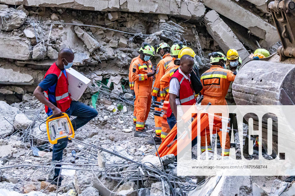 Members of the Kenya Red Cross walk past the site of a collapsed multi-storey building under construction in Eastleigh, Nairobi, as search and rescue operations continue. Rescuers from multiple emergency response agencies conduct search and rescue operations at the site of a collapsed multi-storey building under construction in Eastleigh, Nairobi, Kenya. An unconfirmed number of people are feared trapped beneath the rubble. Nairobi Kenya - ZUMAs197 20261023_aaa_s197_310