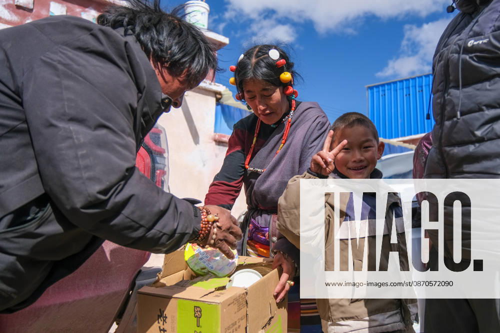 Farmers and herders receive instant noodles and other relief supplies at a resettlement site in Gangqie Township, Baqing County on October 24, 2026 in Nagqu, Xizang Autonomous Region of China. A 7.0 magnitude earthquake struck Baqing County on October 22, killing 16 people and injuring 76, according to local authorities.