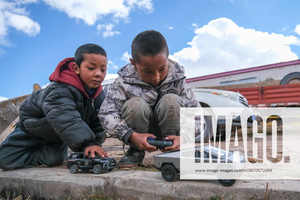 Two children play with remote control toy cars at a relocation site in Gangqie Township, Baqing County on October 24, 2026 in Nagqu, Xizang Autonomous Region of China. A 7.0 magnitude earthquake struck Baqing County on October 22, killing 16 people and injuring 76 others, according to local authorities.