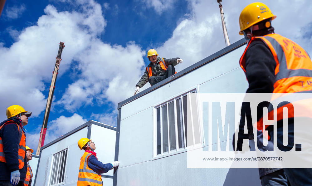 (261024) -- NAGQU, Oct. 24, 2026 -- Workers of China Railway Group Limited build a prefabricated house at a quake-hit village in Maru Township of Baqen County, Nagqu City, southwest China s Xizang Autonomous Region, Oct. 24, 2026. The first batch of prefabricated houses has been set up on Saturday for the affected residents in a village of Maru Township, one of the hardest-hit areas near the epicenter, following a 7.0-magnitude earthquake that struck Baqen County of the city of Nagqu in southwest China s Xizang Autonomous Region at 10:33 p.m. on Thursday. ) (SpotNews) CHINA-XIZANG-NAGQU-EARTHQUAKE-RESETTLEMENT (CN) TenzinxNyida