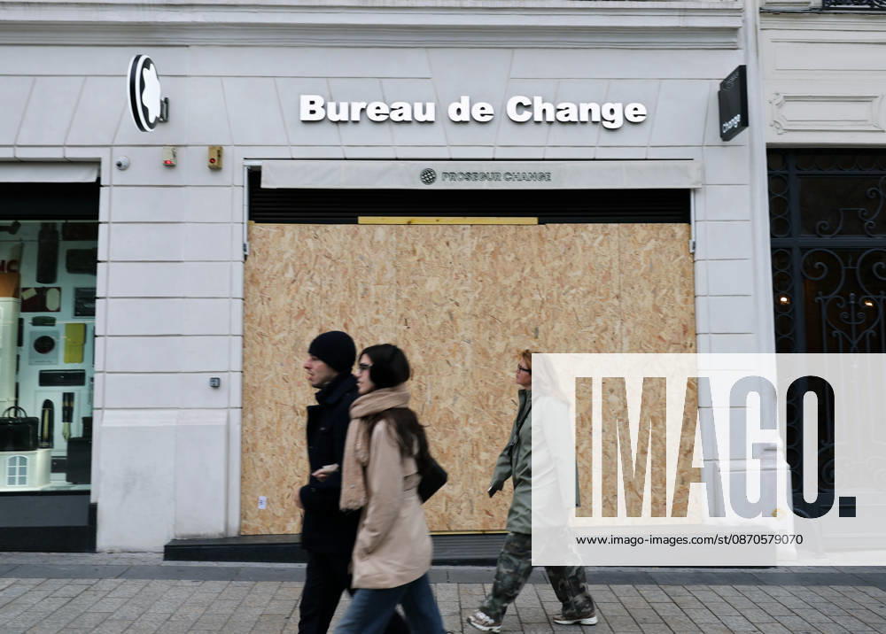(261024) -- PARIS, Oct. 24, 2026 -- People walk past a boarded-up shop on the Avenue Champs-Elysees in Paris, France, Oct. 24, 2026. French Interior Minister Laurent Nunez said Tuesday that the government would deploy soldiers from the French army s Operation Sentinelle to help prevent violence during the demonstrations announced for Oct. 24. ) FRANCE-PARIS-PROTEST-SECURITY WuxHuiwo