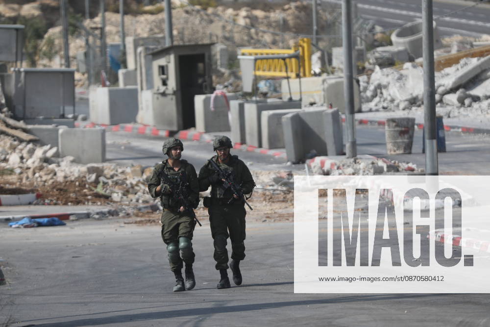 Israeli Soldiers and Military Vehicles Deployed Near Checkpoint in Hebron Israeli soldiers and military vehicles are deployed near a checkpoint where a shooting attack took place in the West Bank city of Hebron, on October 24, 2026. The deployment comes amid continuing Israeli military operations and heightened security measures in the area. Photo by Mamoun Wazwaz apaimages Hebron West Bank Palestinian Territory 241026_Hebron_MW_04(23)