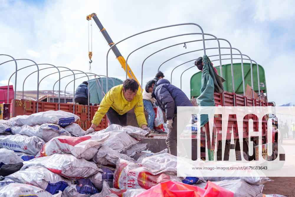 (261024) -- NAGQU, Oct. 24, 2026 -- Staff members transfer coal for heating at a quake-hit village in Maru Township of Baqen County, Nagqu City, southwest China s Xizang Autonomous Region, Oct. 24, 2026. As of 11 a.m. Saturday, 52,450 items or sets of disaster relief supplies had been sent to the quake zone, while more than 2,500 rescue personnel were engaged in relief operations. Authorities have established 35 temporary resettlement sites in the disaster zone. Medical treatment and public health and epidemic prevention efforts are proceeding in an orderly manner, according to the local emergency command headquarters. ) (SpotNews) CHINA-XIZANG-NAGQU-EARTHQUAKE-RELIEF WORK (CN) TenzinxNyida