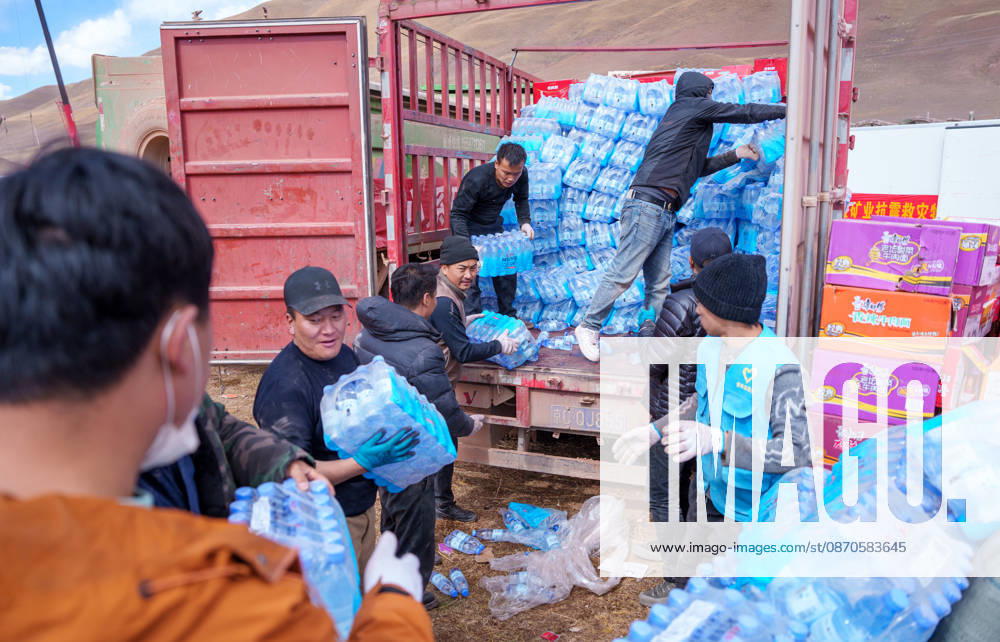 (261024) -- NAGQU, Oct. 24, 2026 -- Staff members transfer bottled water at a quake-hit village in Maru Township of Baqen County, Nagqu City, southwest China s Xizang Autonomous Region, Oct. 24, 2026. As of 11 a.m. Saturday, 52,450 items or sets of disaster relief supplies had been sent to the quake zone, while more than 2,500 rescue personnel were engaged in relief operations. Authorities have established 35 temporary resettlement sites in the disaster zone. Medical treatment and public health and epidemic prevention efforts are proceeding in an orderly manner, according to the local emergency command headquarters. ) (SpotNews) CHINA-XIZANG-NAGQU-EARTHQUAKE-RELIEF WORK (CN) TenzinxNyida