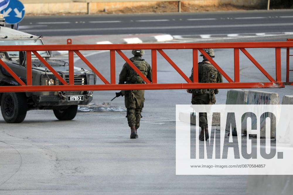 (261024) -- HEBRON, Oct. 24, 2026 -- Israeli military forces are seen at an Israeli military checkpoint near the northern entrance to Hebron City, in the West Bank, on Oct. 24, 2026. Israeli forces launched a military operation in the West Bank city of Hebron on Friday night, hours after Israeli leaders vowed to displace residents and carry out demolitions following a shooting attack near the city that killed two Israeli soldiers. Prime Minister Benjamin Netanyahu also vowed to expand military operations and demolitions in Hebron, four days before Israel s parliamentary election. (Photo by Xinhua) MIDEAST-HEBRON-MILITARY-OPERATION MamounxWazwaz