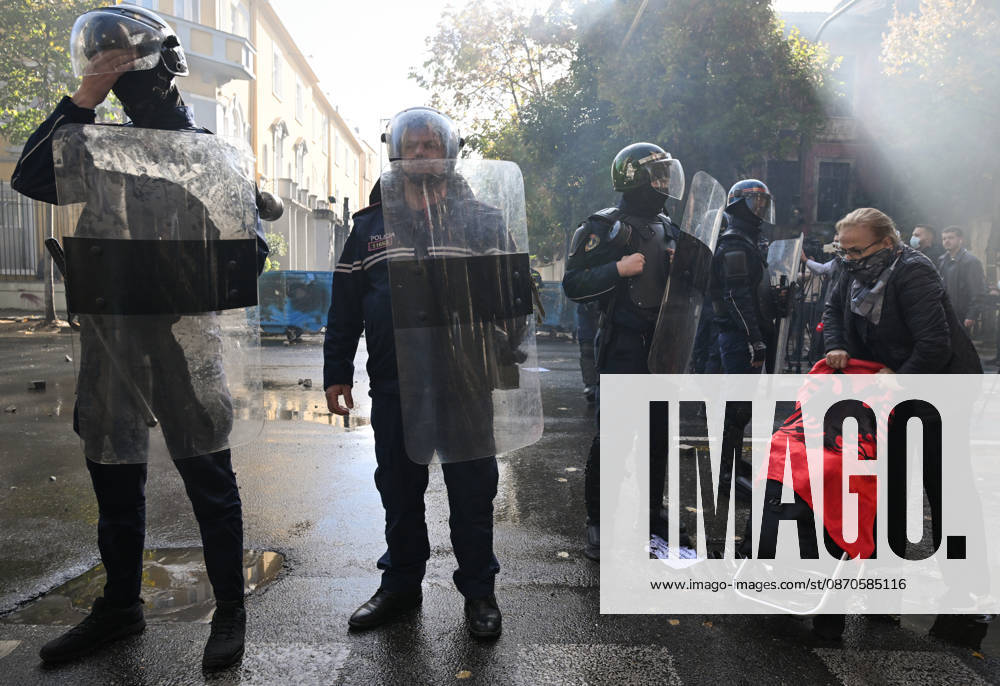 Mass Anti-Government National Protest in Tirana TIRANA, ALBANIA - OCTOBER 24: An elderly woman walks by a line of heavily armored riot police officers on October 24, 2026, in Tirana, Albania. Unrest and physical confrontations erupt in Tirana city center as demonstrators and riot police clash during a massive nationwide protest, turning the capital s main avenue into a major flashpoint as chaotic skirmishes broke out between security forces and factions of the crowd. Artur Widak Anadolu Tirana Albania. Editorial use only. Please get in touch for any other usage.