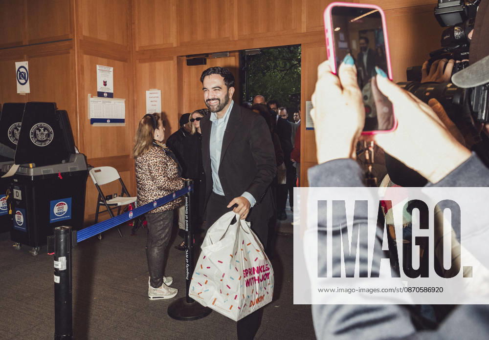 New York City Mayor ZOHRAN MAMDANI carries a bag filled with Dunkin Donuts for election volunteers right before he casts his early voting ballot at the Metropolitan Museum of Art in Manhattan. New York USA - ZUMAp287 20261024_znp_p287_002