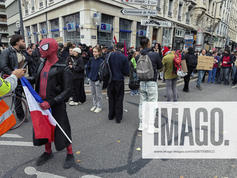 Lyon France Anti-Government Protest A demonstrator wearing a Spider-Man mask holds a French flag as protesters gather on a street in Lyon, France, on October 24, 2026. The demonstration took place amid renewed protests over living costs, wages and public services, while authorities restricted gatherings in parts of central Lyon following unrest during demonstrations the previous weekend. Lyon Rhone Alpes France