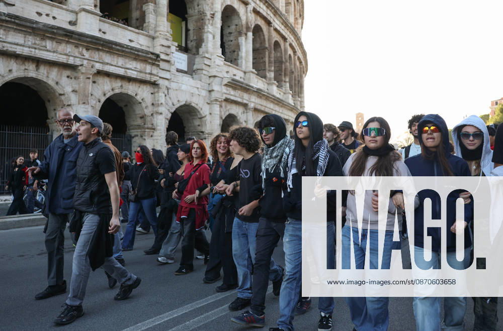 (261024) -- ROME, Oct. 24, 2026 -- Demonstrators march past the Colosseum during an anti-war march in Rome, Italy, Oct. 24, 2026. Protests over rising living costs, military expansion and increased arms spending swept across several Italian cities on Saturday, with clashes between demonstrators and police reported in multiple locations. In Rome, demonstrators set off from Piazza della Repubblica, according to the ANSA news agency. Clashes erupted between protesters and police in the city center later in the evening, prompting police to use water cannons and tear gas in an attempt to disperse the crowds. ) ITALY-ROME-PROTESTS WangxKaiyan