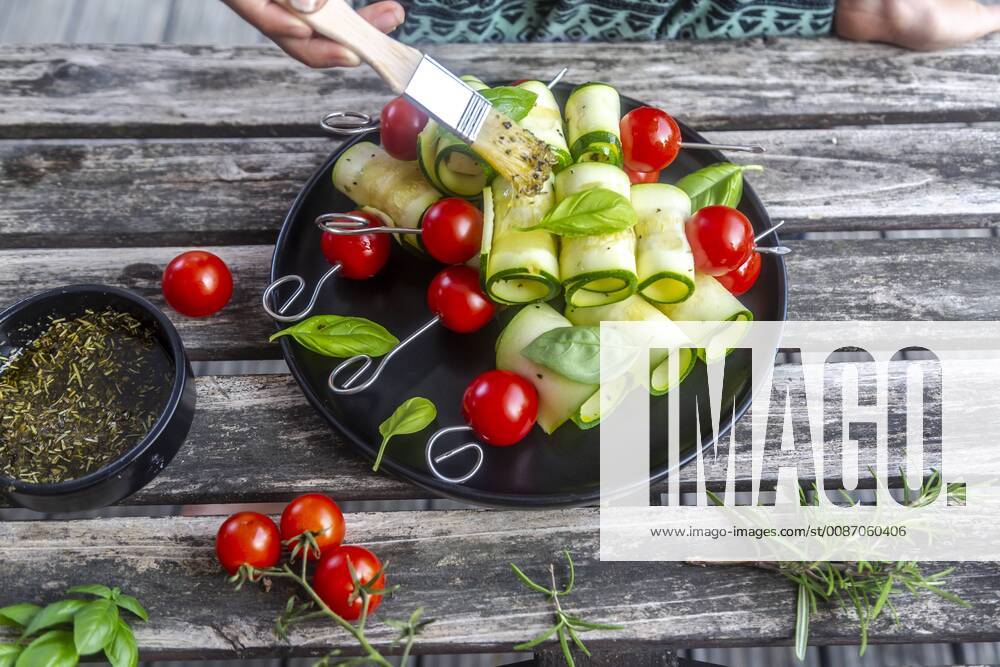 Vegetarian grill skewers, tomato and zucchini slices, brush with rosemary garlic oil model released Symbolfoto SARF03938