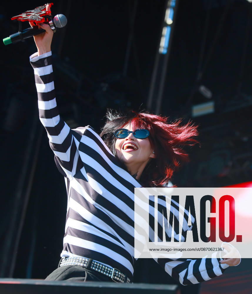 Mexican alternative pop singer BRUSES holds up her microphone with a red custom emblem while performing live on stage during the Tecate Peninsula 2026 music festival at Explanada Estadio Caliente in Tijuana, Baja California, Mexico, October 24, 2026. She wears sunglasses and a black-and-white striped long-sleeve top. Tijuana Mexico - ZUMAm311 20261024_zip_m311_007