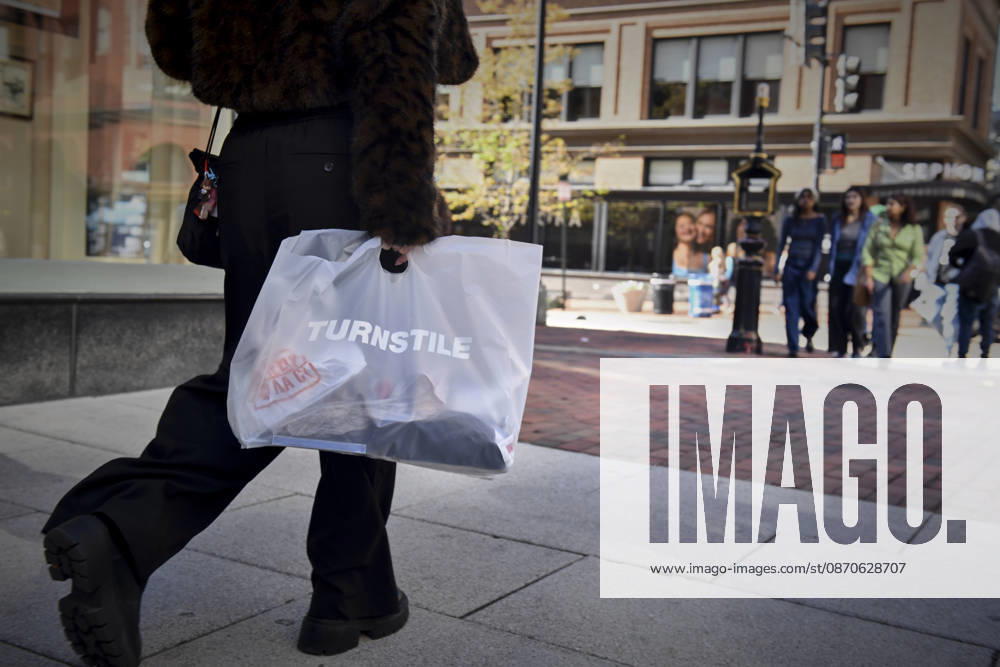 A person walks with merchandise from a pop-up store for Turnstile, a Grammy award-winning hardcore-punk band from Baltimore, MD. The pop-up was part of a free show on the National Mall in Washington DC, Oct. 24, 2026. The show was a benefit for people affected by wars in Palestine, Lebanon and Sudan. Washington Dc USA - ZUMAg216 20261024_znp_g216_008