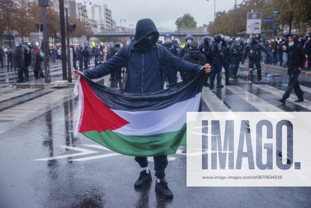 Paris Street Protest A protester displays a Palestinian flag in front of police officers in Paris, France on October 24, 2026. Authorities deployed around 70,000 security personnel across France for renewed protests over the cost of living on October 24, after unrest a week earlier saw public buildings vandalized, hundreds of shops looted and about 2,700 people arrested. Paris Ile de France France