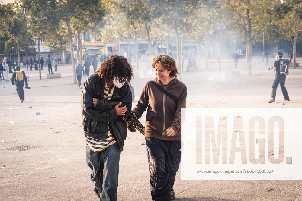 Marseille France Street Protests Two demonstrators walk amid smoke during a protest in Marseille, France on October 24, 2026. Authorities deployed around 70,000 security personnel across France for renewed protests over the cost of living, after unrest a week earlier saw public buildings damaged, hundreds of shops looted and about 2,700 people arrested. Marseille Provence-Alpes-CÃ te France