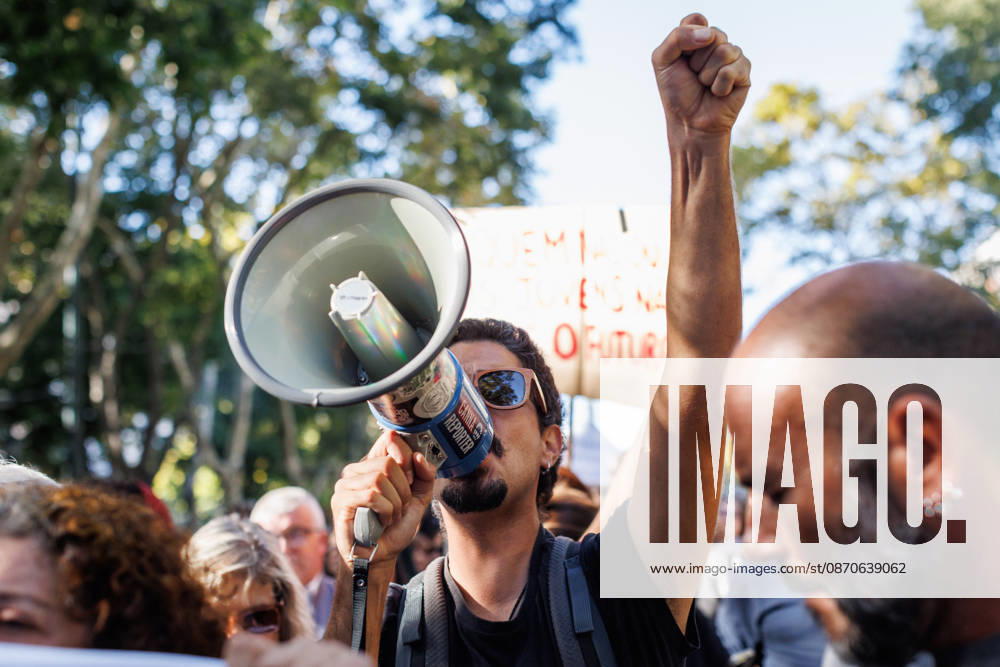 A protester with a raised fist, holds a megaphone at the front line during the demonstration. People march through central Lisbon during a demonstration demanding affordable housing and protesting against the rising cost of living. The protest started at Marques de Pombal and ended at Rossio Square, where demonstrators set up tents at the end of the march in protest against Portugal s housing crisis. Lisbon Portugal - ZUMAs197 20261024_aaa_s197_593