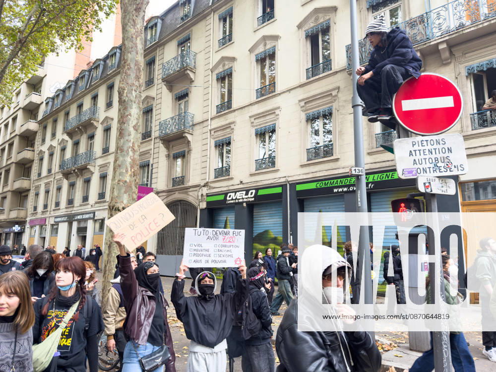 Lyon France Protests October 24 Two demonstrators hold signs during a protest in Lyon, France on October 24, 2026. Authorities deployed around 70,000 security personnel across France for renewed protests over the cost of living, after unrest a week earlier saw public buildings damaged, hundreds of shops looted and about 2,700 people arrested. Lyon Rhone Alpes France
