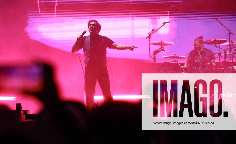 October 24, 2026, Tijuana, Baja California, Mexico: Luis Humberto Navejas of Enjambre performs on stage under intense magenta lighting as audience members capture the show on mobile phones during the Tecate Peninsula 2026 music festival in Tijuana. Tijuana Mexico - ZUMAm311 20261024_zip_m311_019