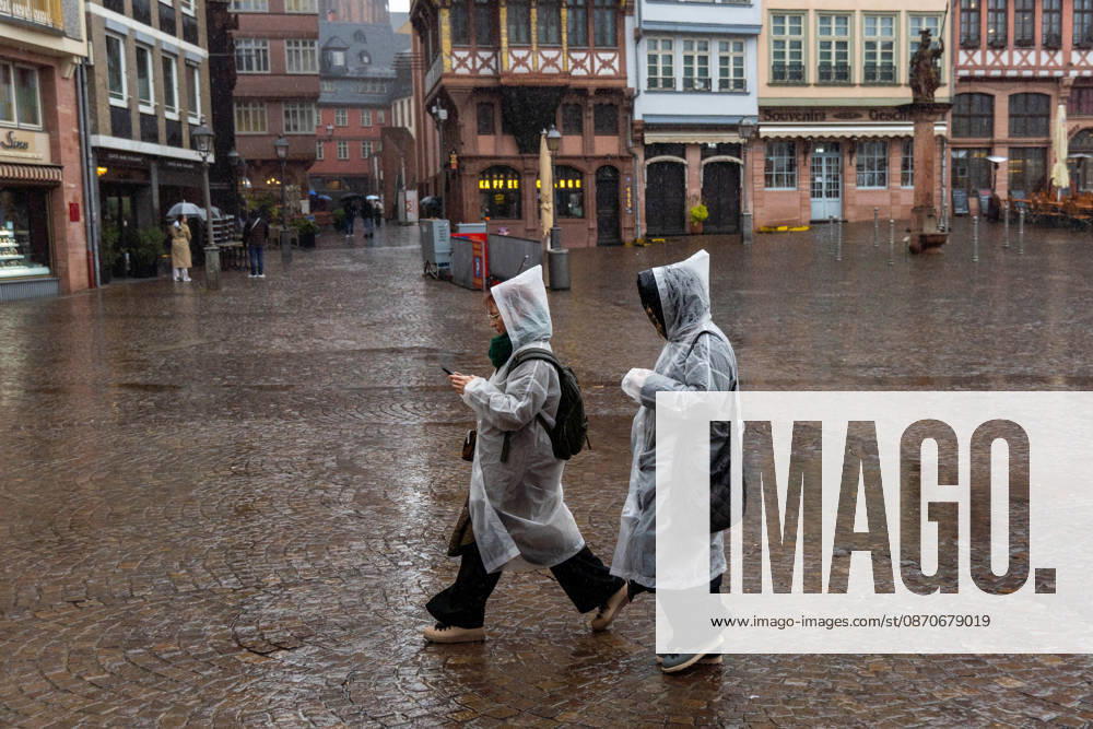 Tourists wearing rain covers walk through the city on a rainy day in Frankfurt am Main, Germany. Frankfurt Germany - ZUMAb332 20261025_zip_b332_002
