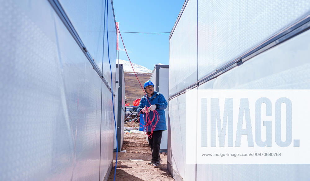 (261025) -- BAQEN, Oct. 25, 2026 -- An electric worker installs power supply lines at a resettlement site of a quake-hit village in Maru Township of Baqen County, Nagqu City, southwest China s Xizang Autonomous Region, Oct. 25, 2026. Power supply lines are being installed for prefabricated houses in the quake-hit Baqen County. According to the State Grid, power connection supplies for 2,724 tents and 2,400 prefabricated houses have been deployed to meet electricity connection needs in the quake-hit area. ) CHINA-XIZANG-EARTHQUAKE-POWER SUPPLY LINES (CN) TenzinxNyida