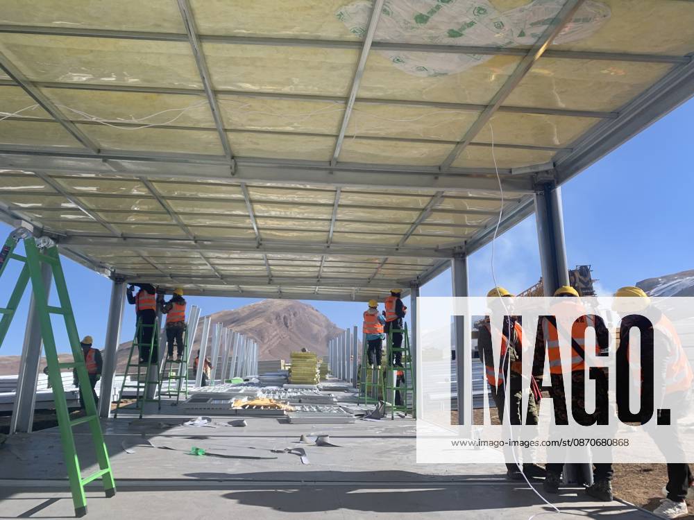 (261025) -- BAQEN, Oct. 25, 2026 () -- Rescuers from the China Railway 20th Bureau Group Corporation Limited build prefabricated houses at a quake-hit village in Gangchen Township of Baqen County, Nagqu City, southwest China s Xizang Autonomous Region, Oct. 25, 2026. Rescue and relief efforts continue after a 7.0-magnitude earthquake struck Baqen County of the city of Nagqu in southwest China s Xizang Autonomous Region, local authorities said Saturday. The roof panels of the first batch of prefabricated houses have been installed in Sunday afternoon in the quake-hit village in Gangchen Township of Baqen, and the laying of cables and the installation of doors and windows have been advanced successively. Currently, seven prefabricated houses